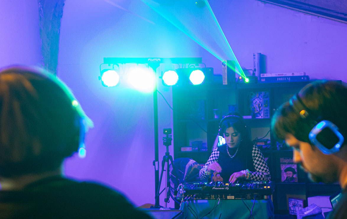 Image of a DJ at what resembles a silent disco event.