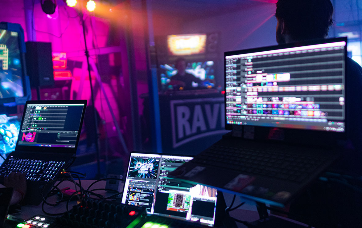 Image of multiple laptops running DJ software.